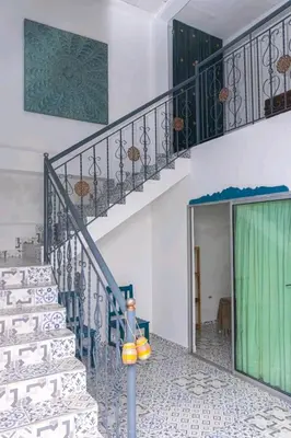 a staircase in a home with a green and white stairvisor at Acantilado getsemani recomendado para familias in Cartagena de Indias