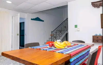 a table with a bunch of bananas and apples on it at Acantilado getsemani recomendado para familias in Cartagena de Indias