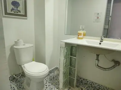 a bathroom with a toilet and a sink at Acantilado getsemani recomendado para familias in Cartagena de Indias