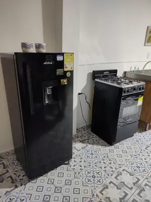 a black refrigerator next to a stove in a kitchen at Acantilado getsemani recomendado para familias in Cartagena de Indias
