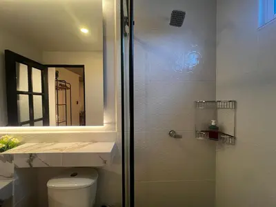 a bathroom with a shower with a toilet and a mirror at Fancy Lunar Studio Near Old Town in Cartagena de Indias