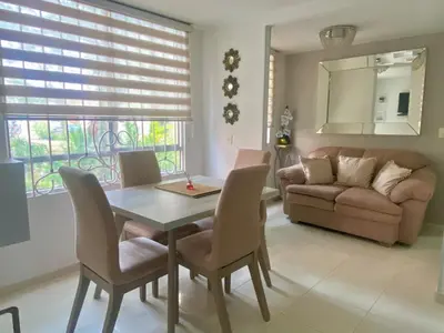 a living room with a table and chairs and a couch at Apartamento acogedor y económico in Barranquilla