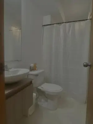 a white bathroom with a toilet and a sink at Apartamento acogedor y económico in Barranquilla