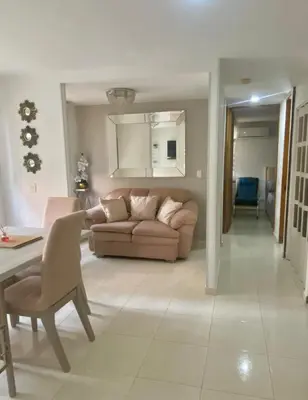 a living room with a couch and a table at Apartamento acogedor y económico in Barranquilla