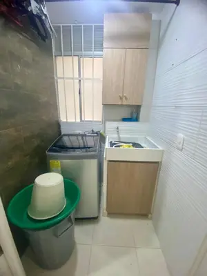 a small kitchen with a sink and a trash can at Apartamento acogedor y económico in Barranquilla