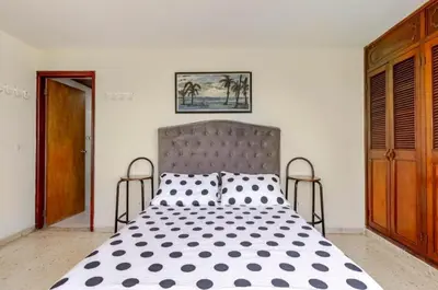 a bedroom with a large bed with black and white polka dots at Hermoso Apto Frente Al Mar in Cartagena de Indias