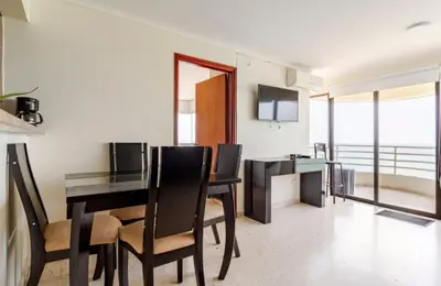 a living room with a dining room table and chairs at Hermoso Apto Frente Al Mar in Cartagena de Indias
