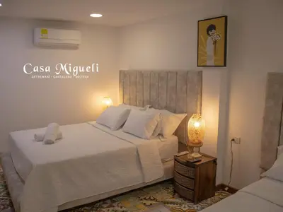 a bedroom with a bed and a lamp on a table at Casa Migueli, exclusiva casa con jacuzzi en terraza in Cartagena de Indias