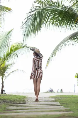 a woman walking on the beach with an umbrella at Clifford Place Morros epic - Direct Beach Access in Cartagena de Indias