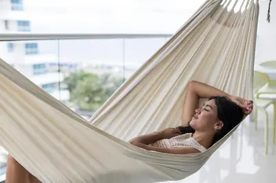 a woman is laying in a hammock at Clifford Place Morros epic - Direct Beach Access in Cartagena de Indias