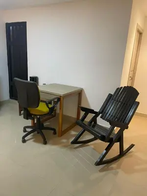 two chairs and a table and a table and a table and chairs at Apartaestudio Barranquilla in Barranquilla