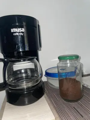 a coffee pot and a jar of coffee on a table at Apartaestudio Barranquilla in Barranquilla