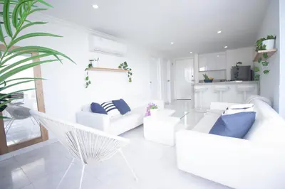 a living room with white furniture and a hammock at Riviera del Mar - Apartamento con vista panorámica al mar in Cartagena de Indias