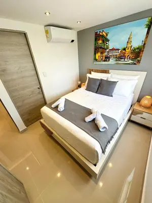 a bedroom with a large bed with towels on it at Luxury apartment with sea view in Cartagena de Indias