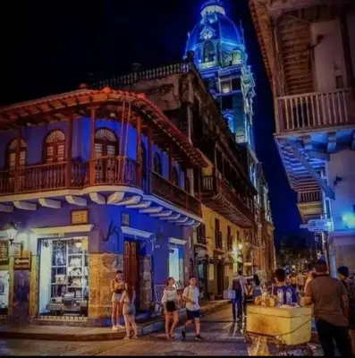 a group of people walking down a street at night at Luxury apartment with sea view in Cartagena de Indias
