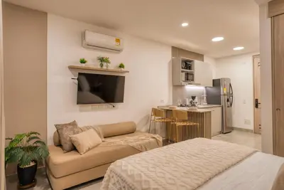 a small living room with a couch and a tv at Maranta Beach in Santa Marta