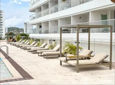 a row of lounge chairs on the side of a building at Exclusive apartment Cartagena in Cartagena de Indias