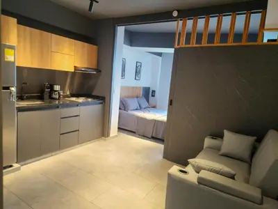 a kitchen and a living room with a couch and a bed at Exclusive apartment Cartagena in Cartagena de Indias