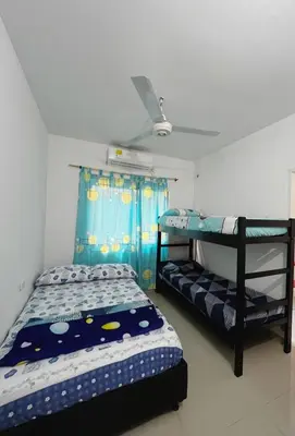 a bedroom with two bunk beds and a ceiling fan at Casa Ingrid in Coveñas