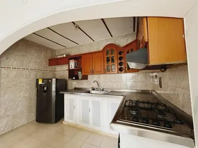 a kitchen with a stove and a refrigerator at Casa Ingrid in Coveñas