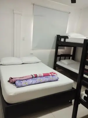 a room with a bed and two bunk beds at Casa Ingrid in Coveñas
