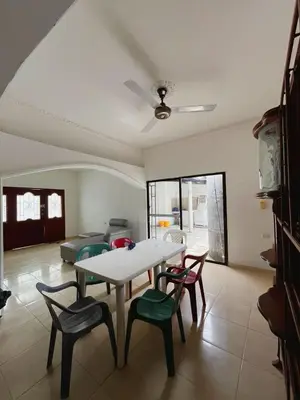 a living room with a table and chairs and a couch at Casa Ingrid in Coveñas
