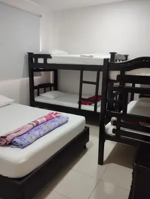 a room with two bunk beds and a table at Casa Ingrid in Coveñas