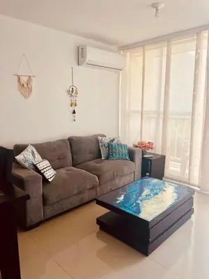 a living room with a couch and a coffee table at Playa Azul in Puerto Colombia