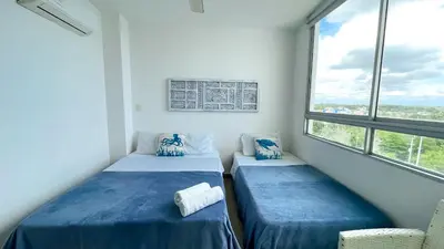 two beds in a room with two windows at Magico Apartamento Frente al Mar 3 Habitaciones MSC64 in Coveñas