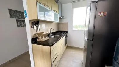 a kitchen with a sink and a refrigerator at Magico Apartamento Frente al Mar 3 Habitaciones MSC64 in Coveñas