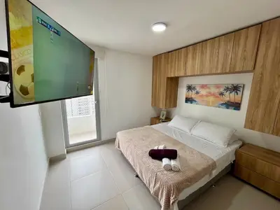 a bedroom with a bed with a flat screen tv at Apto Luxury Cartagena 7 minutos a pie de la playa in Cartagena de Indias