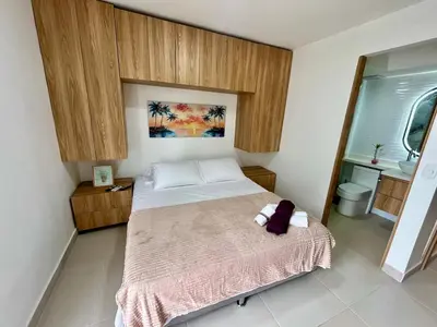 a small bedroom with a bed and a sink at Apto Luxury Cartagena 7 minutos a pie de la playa in Cartagena de Indias