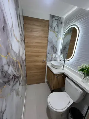 a bathroom with a toilet and a sink and a mirror at Apto Luxury Cartagena 7 minutos a pie de la playa in Cartagena de Indias