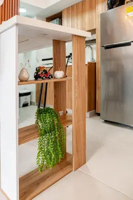 a kitchen with wooden shelves and a plant at Apto Luxury Cartagena 7 minutos a pie de la playa in Cartagena de Indias