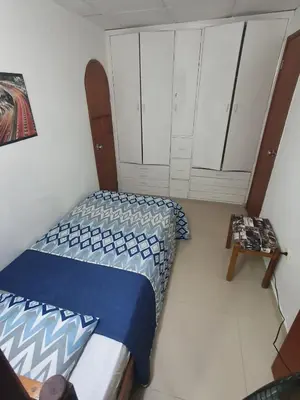 a small bedroom with a bed and white cabinets at Apartamento con balcon p13 in Cartagena de Indias