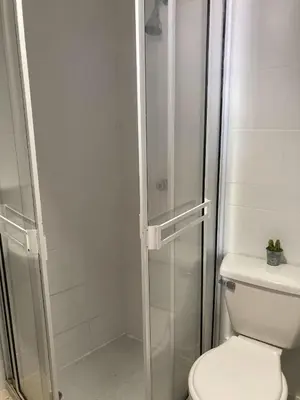 a bathroom with a toilet and a glass shower at Apartamento con balcon p13 in Cartagena de Indias