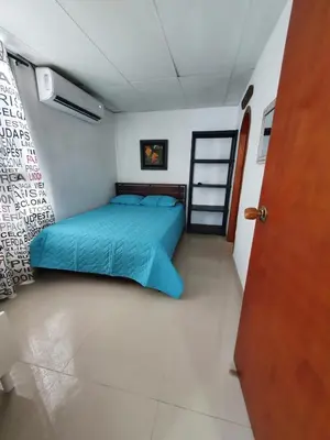 a bedroom with a blue bed in a room at Apartamento con balcon p13 in Cartagena de Indias
