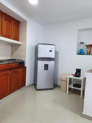 a kitchen with a stainless steel refrigerator in the corner at Apartamento con balcon p13 in Cartagena de Indias