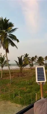 a solar panel on a pole next to a beach at Hostal pura vida in San Bernardo del Viento