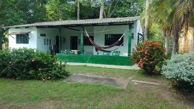 a small house with a hammock in the yard at Tundsya in San Antero