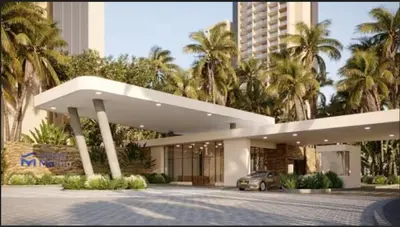 a car parked in front of a building with palm trees at Exclusiva Suite Frente al Mar in Santa Marta