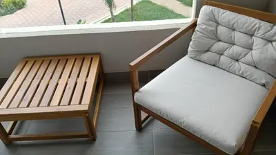 a chair sitting on a balcony next to a window at Exclusiva Suite Frente al Mar in Santa Marta
