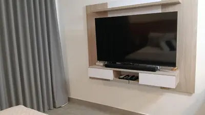 a flat screen tv sitting on a wall at Exclusiva Suite Frente al Mar in Santa Marta