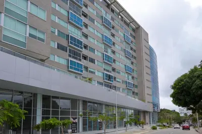 a tall building on a street next to a road at Apto 305 Distrito 90 in Barranquilla