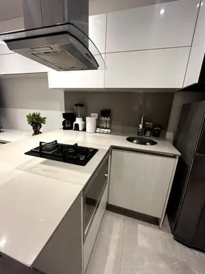 a white kitchen with a stove and a sink at Apto 305 Distrito 90 in Barranquilla