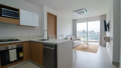 a kitchen with a sink and a stove at New And Luxury Apartment 3BR In Baia Kristal in Los Arrayanes