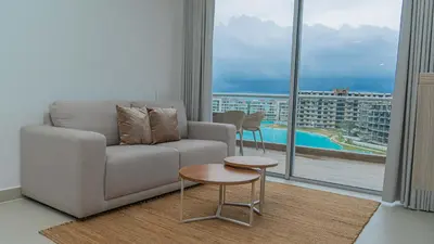 a living room with a couch and a large window at New And Luxury Apartment 3BR In Baia Kristal in Los Arrayanes