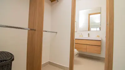 a bathroom with a toilet and a sink and a mirror at New And Luxury Apartment 3BR In Baia Kristal in Los Arrayanes