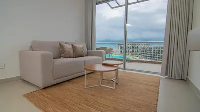 a living room with a couch and a table at New And Luxury Apartment 3BR In Baia Kristal in Los Arrayanes