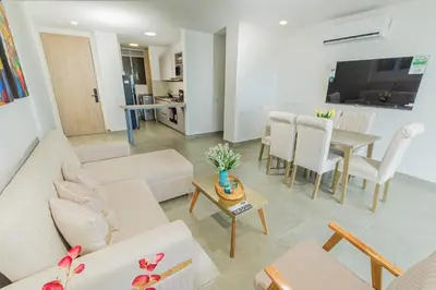 a living room with a couch and a table at Apto 1417 condominio Santa marina, Santa Marta in Estación El Salto